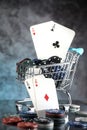 A pair of aces, hearts and diamonds, on a deck of playing cards. Poker playing chips on a dark and light blue background. Royalty Free Stock Photo