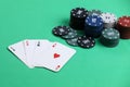 A pair of aces, hearts and diamonds, on a deck of playing cards. Poker playing chips on a green table. Online gambling. Addiction. Royalty Free Stock Photo