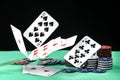 A pair of aces, hearts and diamonds, on a deck of playing cards. Poker playing chips on a green table. Online gambling. Addiction. Royalty Free Stock Photo