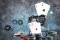 A pair of aces, hearts and diamonds, on a deck of playing cards. Poker playing chips in a blue shopping cart Royalty Free Stock Photo
