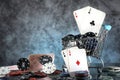 A pair of aces, hearts and diamonds, on a deck of playing cards. Poker playing chips on a dark and light blue background. Royalty Free Stock Photo