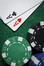 A pair of aces with a pile of poker chips