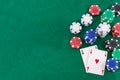 Pair of aces and poker chips on green background whit copy space Royalty Free Stock Photo