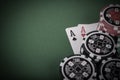 pair of aces, red and black cassino chips on green table - vintage Royalty Free Stock Photo