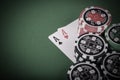 pair of aces, red and black cassino chips on green table - vintage Royalty Free Stock Photo
