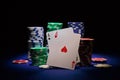 Pair of aces and poker chips on black background Royalty Free Stock Photo