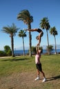 Pair acrobatics. Handstand in straight hands on the rocks by the sea