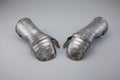 Pair of antique gauntlets on a white background