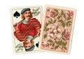 A pair of antique playing cards with the jack of spades revealed.