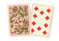 A pair of antique playing cards with the ten of diamonds revealed.