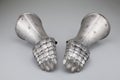 Pair of antique rusty gauntlets on a white background