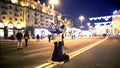 Pair of athletes making risky stunts on street, cool performance in night city