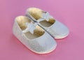 pair of baby shoes. Baby shoes on a pink background. Royalty Free Stock Photo