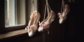 A pair of ballet shoes hanging by their ribbons, evoking the grace and discipline of dance, concept of Artistic