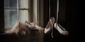 A pair of ballet shoes hanging by their ribbons, evoking the grace and discipline of dance, concept of Artistic