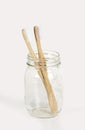 A pair of bamboo toothbrushes on a light background