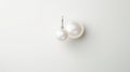 a pair of beautiful and classy pearl earrings made of two large white pearls attached to a thin silver wire. The pearls Royalty Free Stock Photo