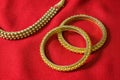 A pair of beautiful Indian gold bangles and gold necklace Royalty Free Stock Photo