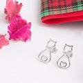 A pair of beautiful 925 sterling silver earrings in cat shape decorated with cubic zirconia Royalty Free Stock Photo