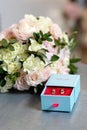 A pair of beautiful wedding rings and a delicate bridal bouquet of roses. Wedding ceremony. Soft selective focus Royalty Free Stock Photo