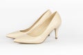 Pair of beige women`s leather shoes on high-heeled on white background. Concept for female shopping and fashion