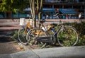 Pair of bicycles locked beside a pavement sidewalk. Dutch style