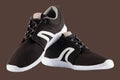 pair of black airmesh summer walking lightweight shoes isolated on brown background