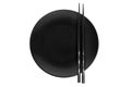Pair of black chopsticks placed on a black plate Royalty Free Stock Photo