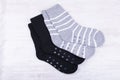 Pair of black and gray woolen socks on white wooden background Royalty Free Stock Photo