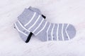 Pair of black and gray woolen socks on white wooden background Royalty Free Stock Photo