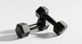 Pair of Black Hexagonal Dumbbells on a White Background weights exercise Royalty Free Stock Photo