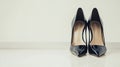 Pair of black high heels are on a white surface Royalty Free Stock Photo