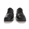 Pair of black leather brogues over white. Front view. 3D illustration