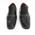 Pair of black leather brogues over white. Front view. 3D illustration