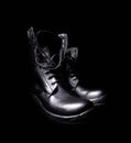 A pair of black leather military boots on black background Royalty Free Stock Photo