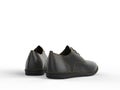 Pair of black oxford shoes with yellow stitching - back view