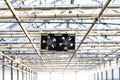 Pair of black small fans under the roof of a greenhouse, air-conditioning, heat wave concept