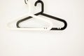 A pair of black and white plastic coat hangers with a trouser bar Royalty Free Stock Photo