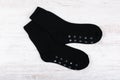 Pair of black woolen socks on white wooden background Royalty Free Stock Photo