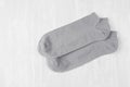 Pair blank grey small, low socks flat lay on white wood board, side view - mock up for design, print, presentation, advertising.