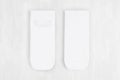 Pair blank white small, low socks flat lay on white wood board, front view, backside - mock up for design, print, presentation.