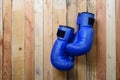 Pair of blue boxing gloves hanging on the wall Royalty Free Stock Photo