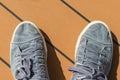 A pair of blue canvas deck shoes on ships deck.