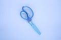 A pair of blue craft scissors for kids