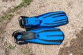 A pair of blue diving fins lies on a concrete slab on a sunny summer day Royalty Free Stock Photo