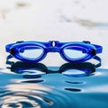 Pair of blue goggles is sitting in a pool of water Royalty Free Stock Photo
