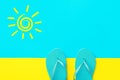 Pair of blue rubber beach slippers on duotone bright yellow cyan background. Imitation of sand and sea. Hand drawn doodle sun Royalty Free Stock Photo