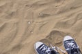 Pair of blue sneakers on beach Royalty Free Stock Photo