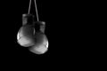 Pair of boxing gloves hanging against a black wall background. Empty copy space Royalty Free Stock Photo