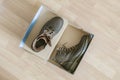 Pair of brand new shoes in shoe cartoon box on wooden floor f Royalty Free Stock Photo